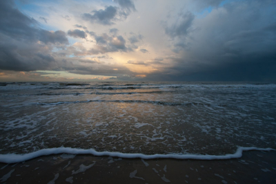 's Ochtends vroeg me bed uit (6uur) om op tijd op het strand te zijn. De zon kwam langzaam achter de duinen op. Af en toe een bui, wat een mooie dreigende lucht veroorzaakte.